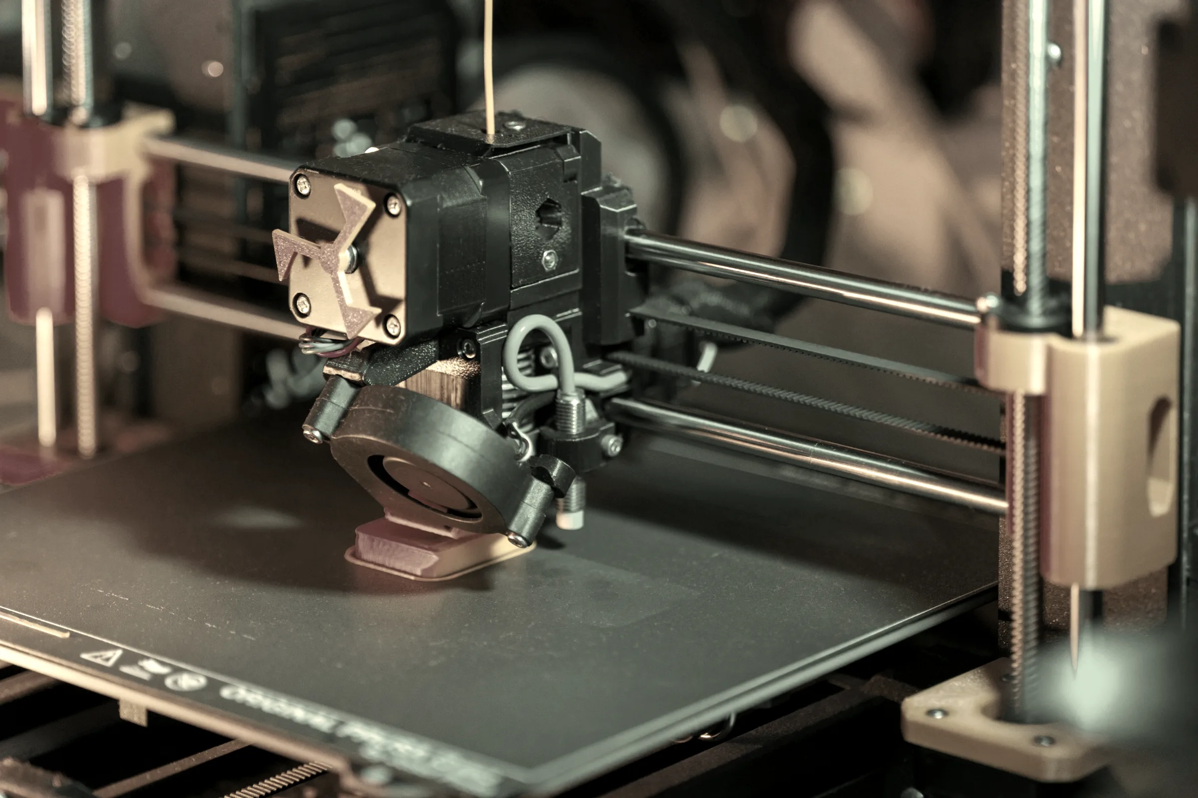 A 3D printer hot-end laying down a layer, close up.